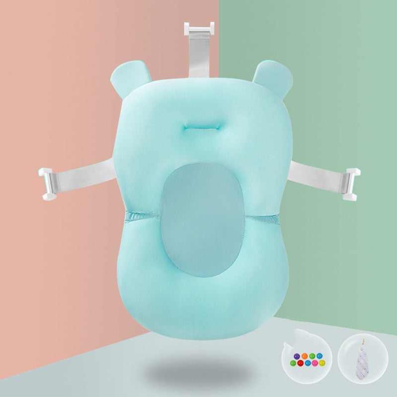 Light blue baby bath pillow with adjustable white straps, designed for support and comfort in water, shown against a two-tone background. Small icons at bottom-right.