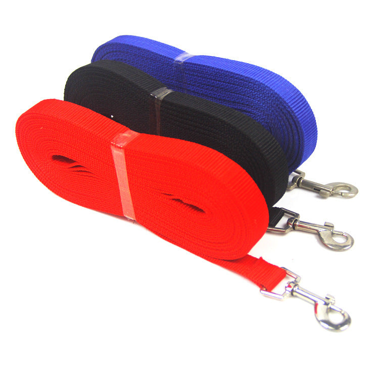 Three rolled nylon dog leashes in red, black, and blue are stacked. Each leash has a metal clasp for attachment, neatly arranged with visible textures.