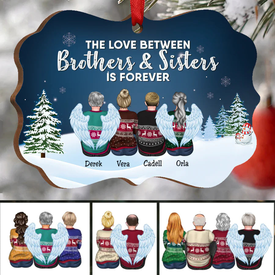 Illustrated ornament depicts four siblings, two with angel wings, in festive sweaters. Snowy landscape and trees in the background with text: "The love between brothers & sisters is forever."