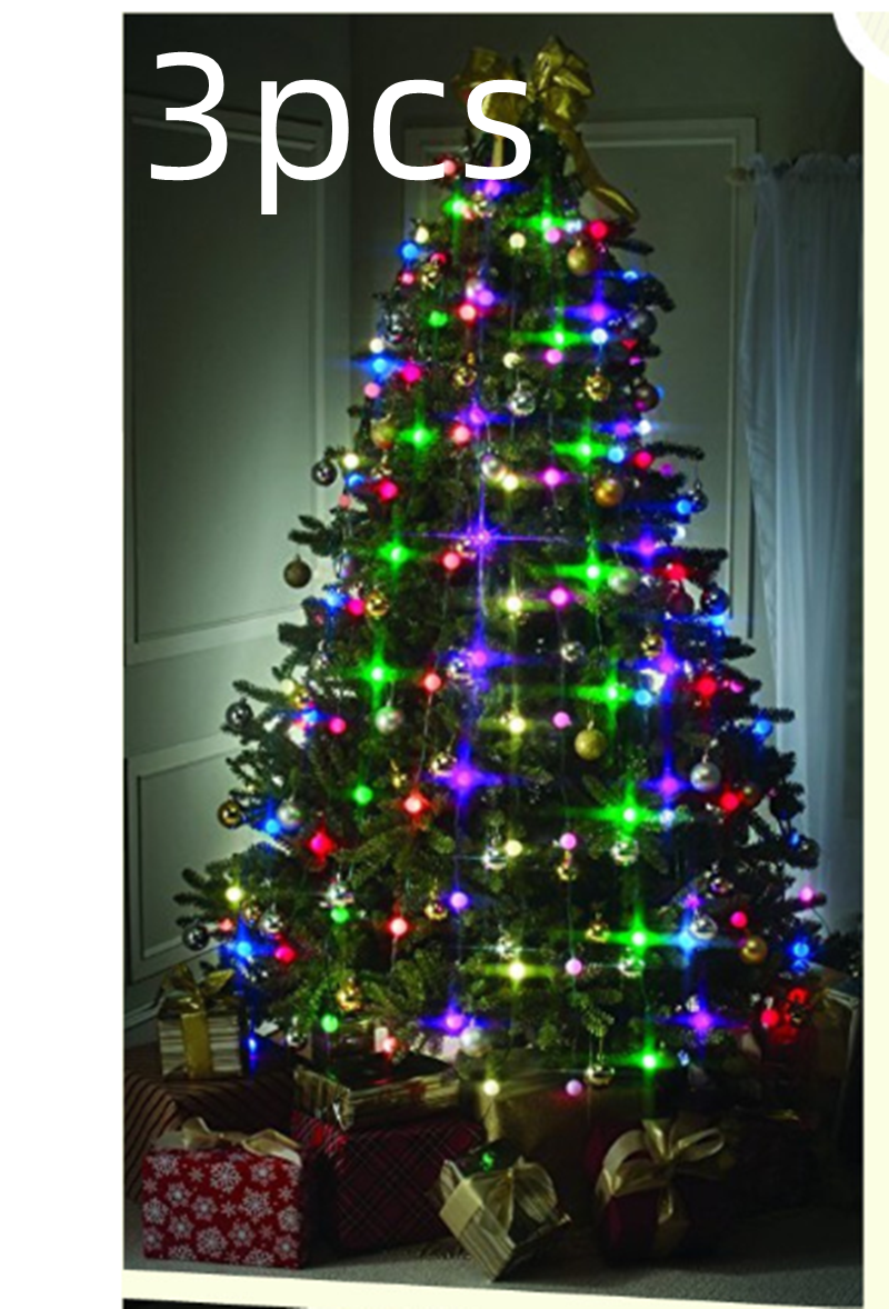 Illuminated Christmas tree with colorful lights, ornaments, and a gold bow on top. Presents are wrapped in festive paper and ribbons underneath. Text reads "3pcs."