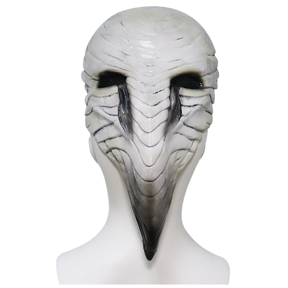 A white, bird-like mask with intricate, layered detailing resembling feathers and a pronounced beak. The eye holes are dark and positioned on either side of the mask.