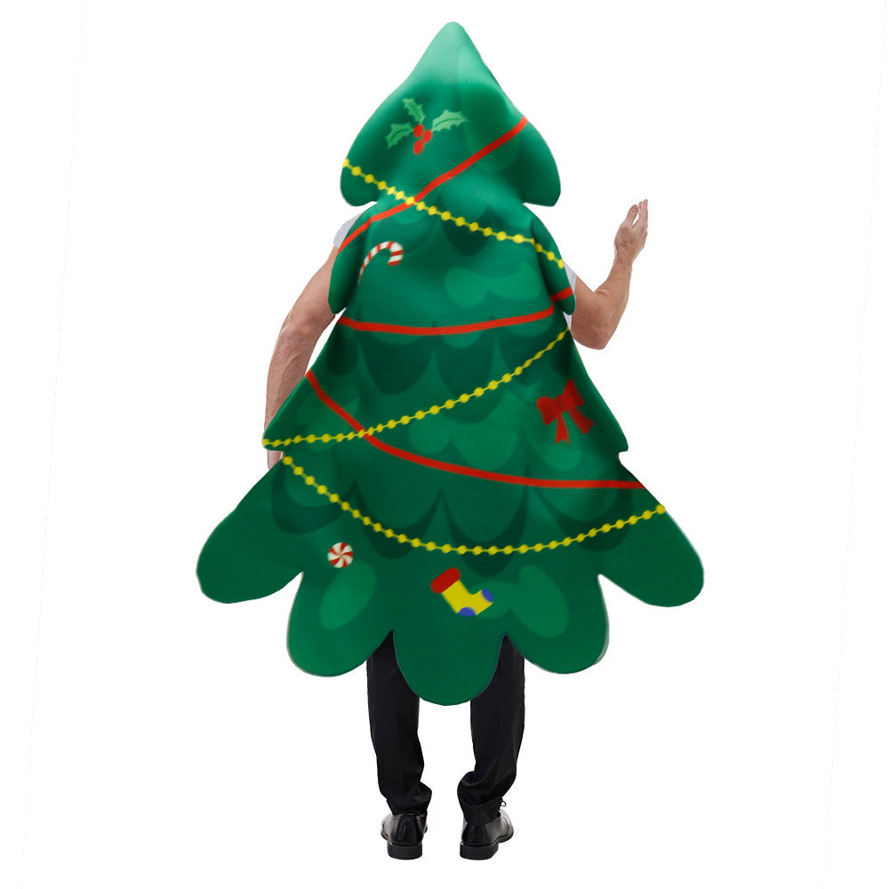 Person wearing a Christmas tree costume adorned with garlands, holly, candy cane, and ornaments, waving. The costume covers them from head to knees, creating a whimsical effect.