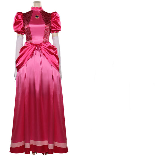 Elegant pink satin gown with puff sleeves, lace detailing, and a rounded collar, featuring a jeweled brooch on the chest. White gloves accompany the dress.