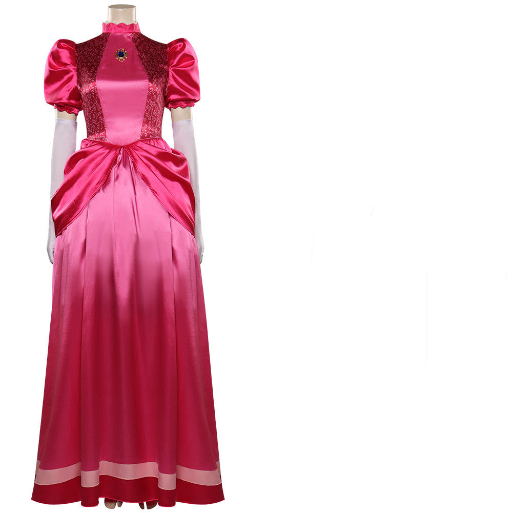 Elegant pink satin gown with puffed sleeves, lace detailing, and a gem brooch. The full-length skirt features layered fabric and a wide pink waistband, reflecting vintage style.