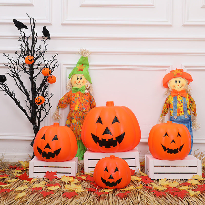 Festive Halloween scene features three jack-o'-lanterns on white crates, surrounded by colorful leaves, with two cheerful scarecrows and a black tree adorned with pumpkins and crows.