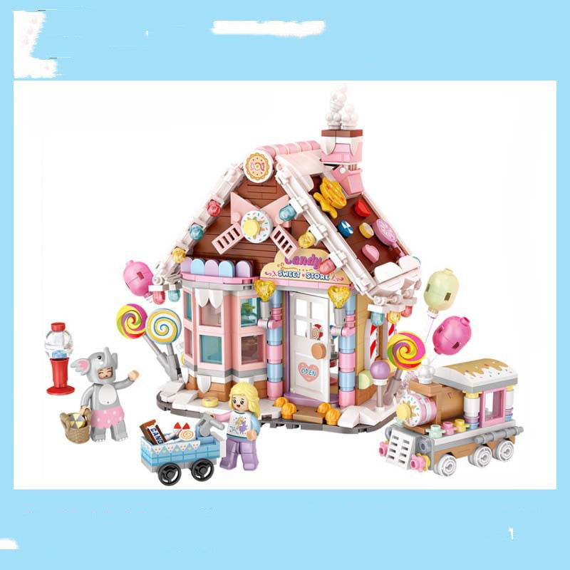 Colorful toy candy store with pastel decorations, lollipops, a pink roof, and miniature figures including a person in a gray costume and a child with a candy cart.