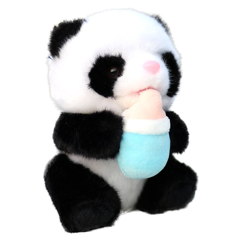 Plush toy panda with black and white fur, holding a light blue baby bottle. The toy has a pink nose and large dark eyes, giving it an adorable and cuddly appearance.
