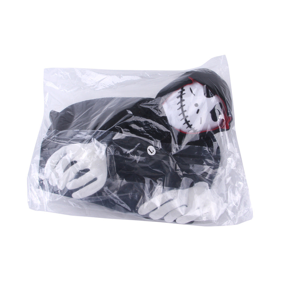 A plush toy depicting a skeleton with a stitched smile and dark hooded cloak, packaged in a transparent plastic bag with a visible "L" size label.