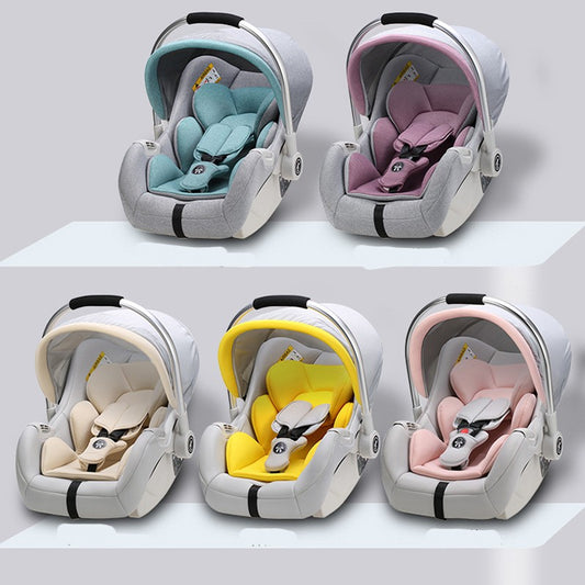 Five infant car seats in various colors: teal, pink, beige, yellow, and baby pink. Each seat features a canopy and harness, set against a simple gray background.