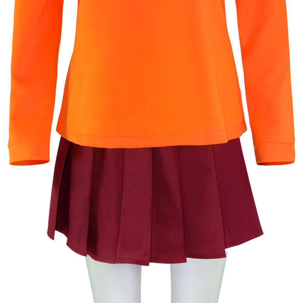 Bright orange long-sleeve shirt paired with a maroon pleated skirt displayed on a mannequin, showing a contrast of vibrant colors and textures.