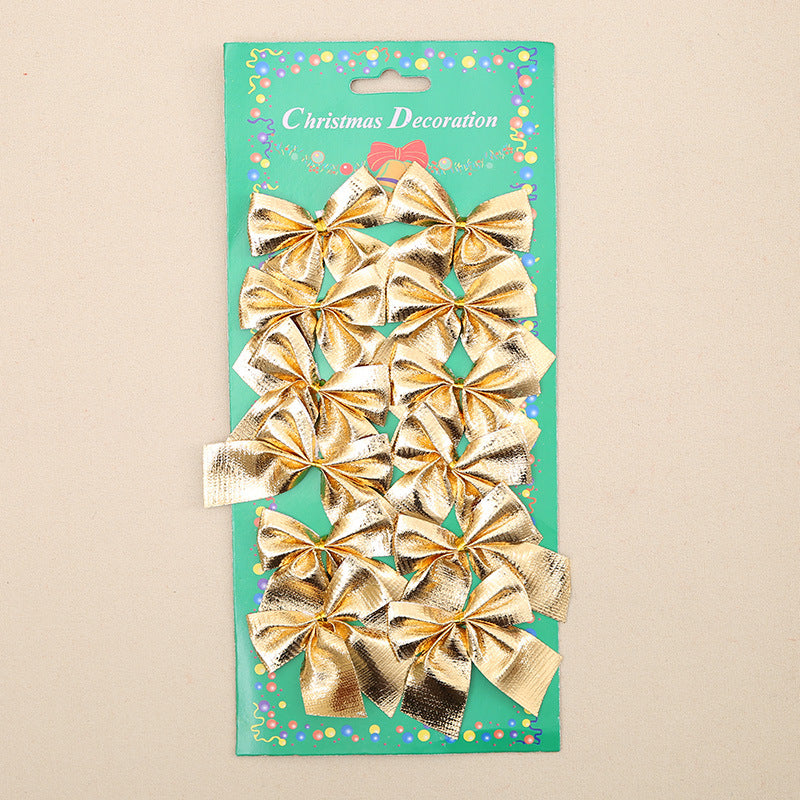 A package of gold Christmas bows on a green card titled "Christmas Decoration," adorned with colorful dots. The bows are shiny and neatly arranged in rows.