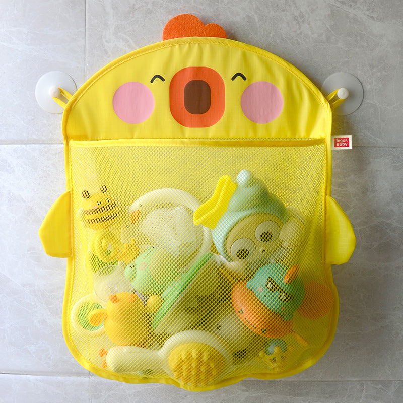 A yellow mesh bath organizer shaped like a cheerful chick holds various colorful toys. It's attached to a tiled wall with suction cups.