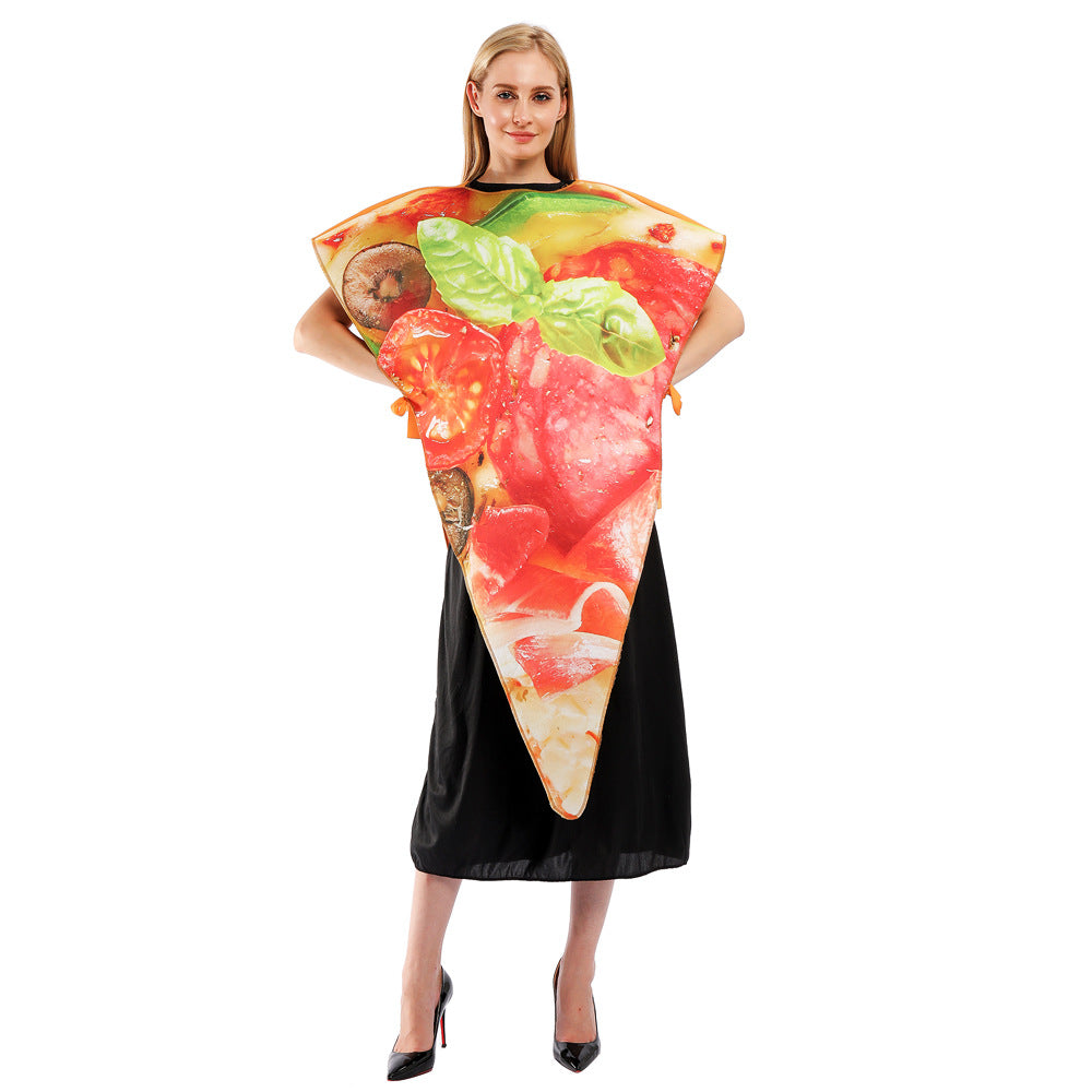 A person stands smiling in a pizza slice costume featuring vibrant toppings, including tomatoes, basil, pepperoni, and mushrooms. The costume is over a black dress, and they wear black high heels. The background is plain white.