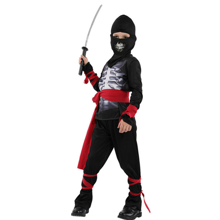 Child in a black ninja costume with skeleton print and red accents. Wielding a sword, the child wears a hooded mask with a skull design, striking a confident pose.