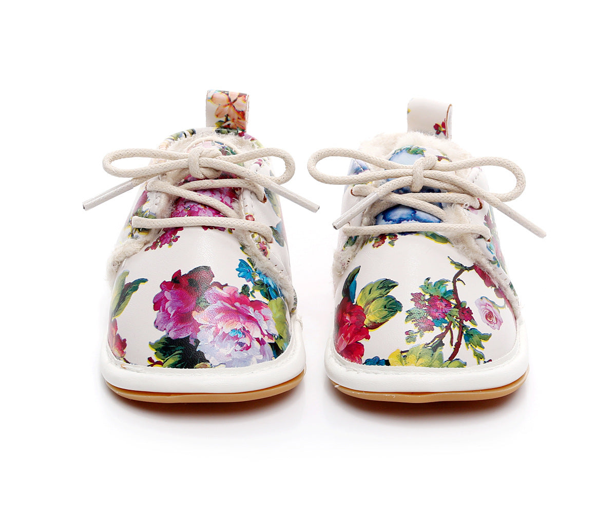 Floral-patterned baby shoes with white laces and soft lining, featuring vibrant pink, blue, and green flowers on a white background.