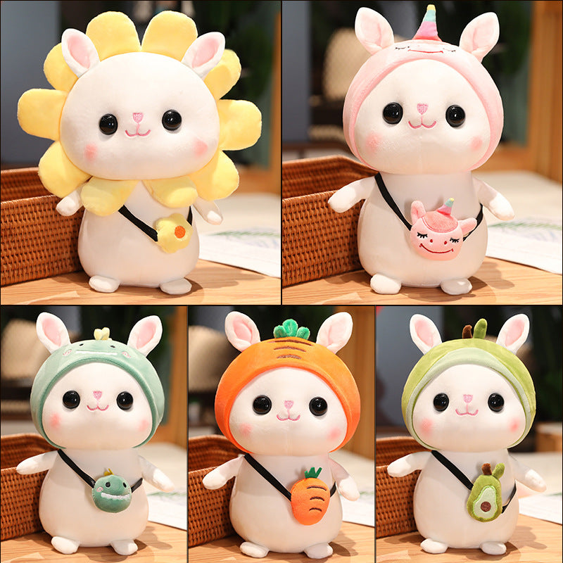 Cute plush dolls dressed in themed costumes: sunflower, unicorn, green dinosaur, carrot, and avocado. Each holds a small matching accessory on its side.