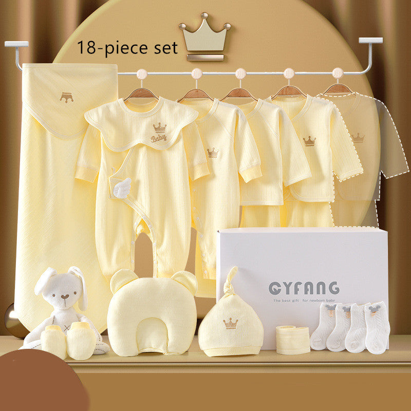 Yellow baby clothing 18-piece set with onesies, hats, socks, a blanket, and a plush toy. Displayed on hangers with a gift box and crown motifs.