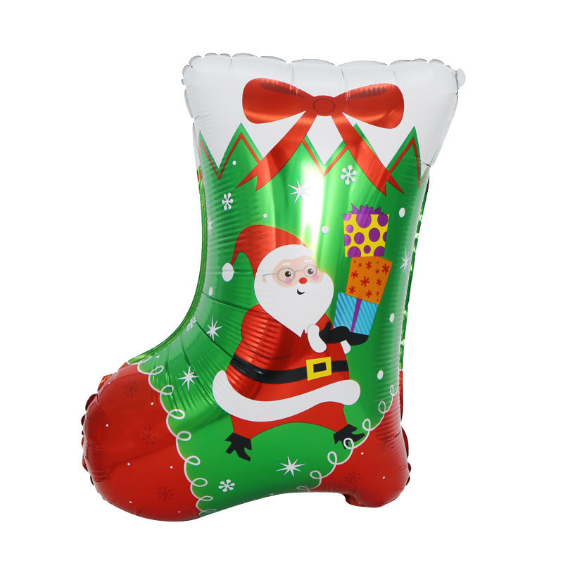 Festive balloon shaped like a Christmas stocking, featuring a Santa Claus design with a red suit and hat, holding colorful presents. Decorated with snowflakes and a large red bow.