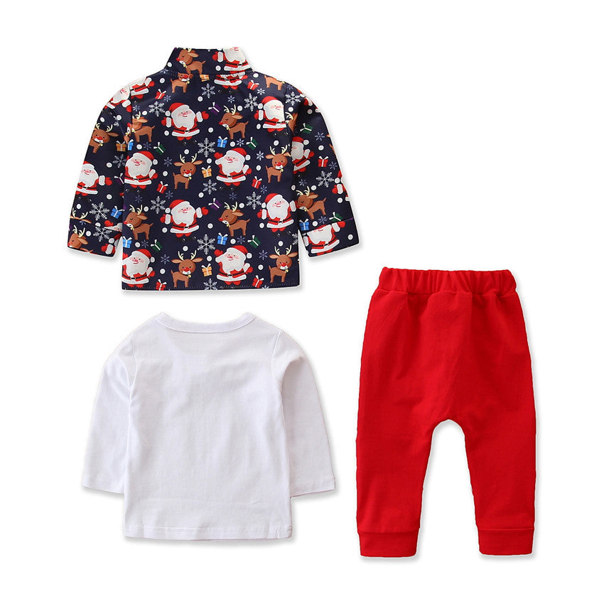 Three-piece toddler outfit: a navy jacket with festive Santa and reindeer print, a plain white long-sleeve shirt, and bright red pants, all against a white background.