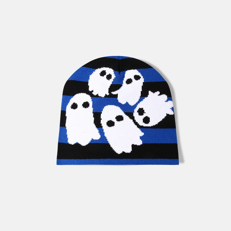 Beanie with blue and black stripes featuring white cartoon ghosts with black eyes scattered across the surface, set against a plain background.
