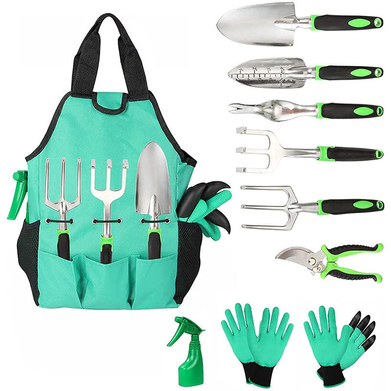 Garden tool set with green and black handles, including trowels, forks, pruners, spray bottle, and gloves. Tools organized in a green apron with pockets.