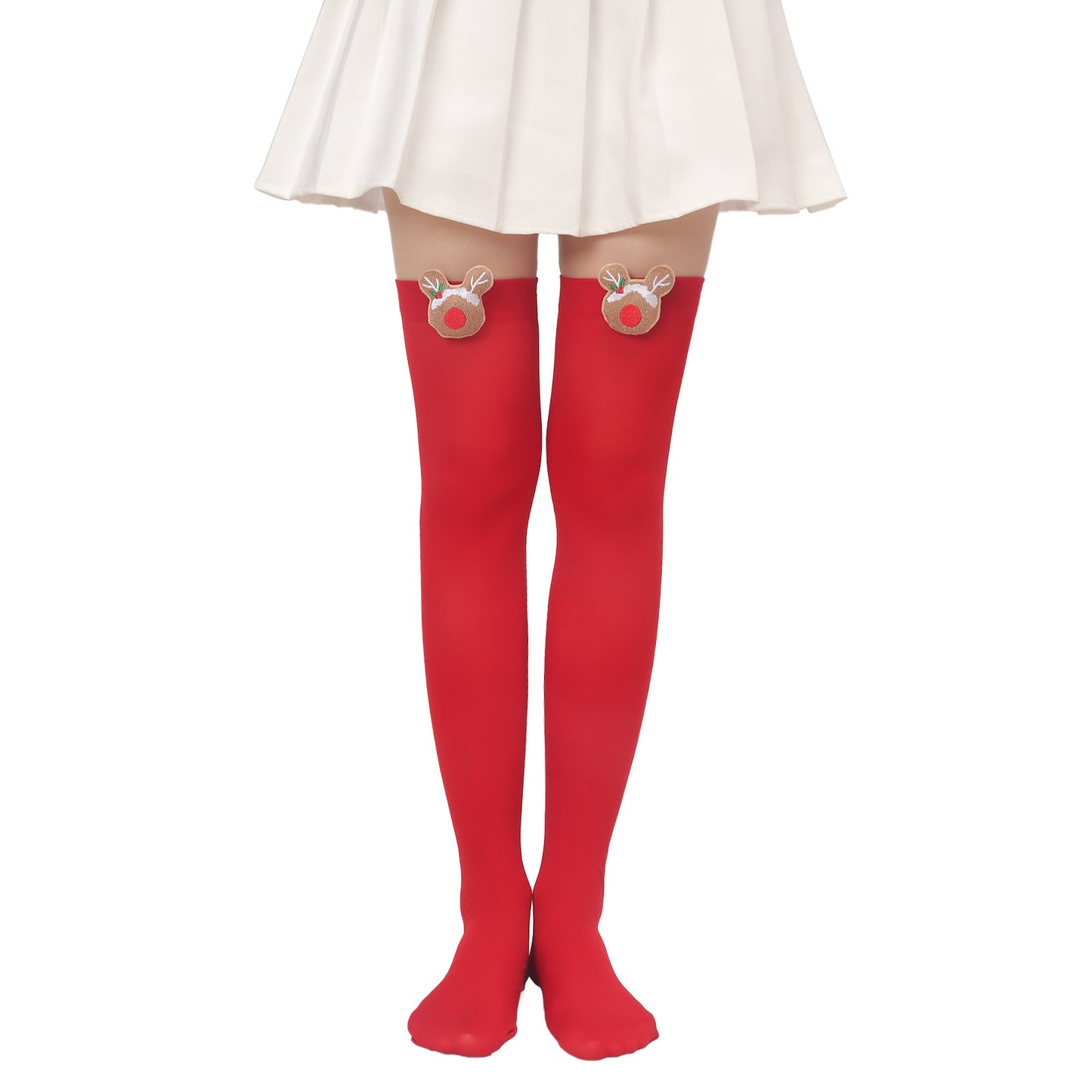 A person wearing bright red thigh-high stockings with reindeer patches near the top, paired with a white skirt.