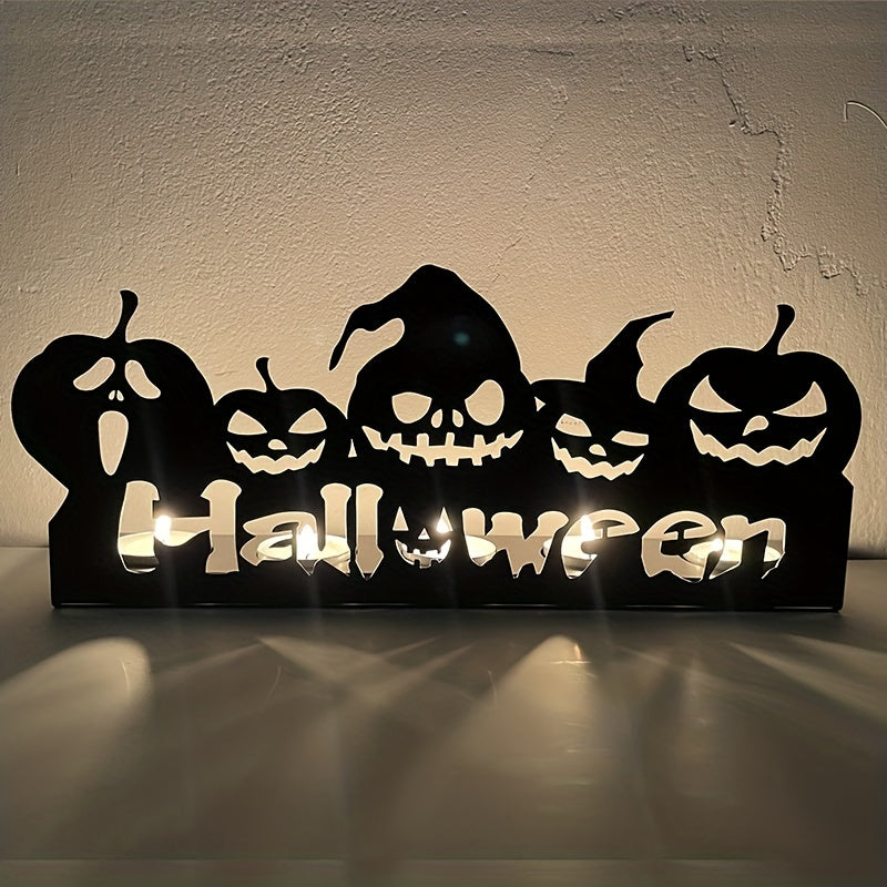 Silhouette of carved jack-o'-lantern faces with illuminated "Halloween" text below. The backdrop is a textured wall with subtle lighting highlights.