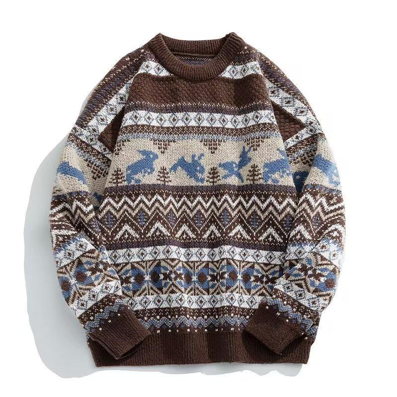 Brown knitted sweater with intricate white, beige, and blue patterns featuring birds and geometric shapes. The design includes zigzags and circular motifs.