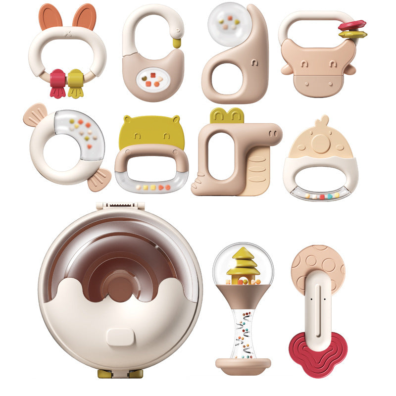 A collection of animal-shaped baby rattles in soft pastel colors, including designs like a rabbit, hippo, and bird. Each rattle features different shapes and textures for sensory play.
