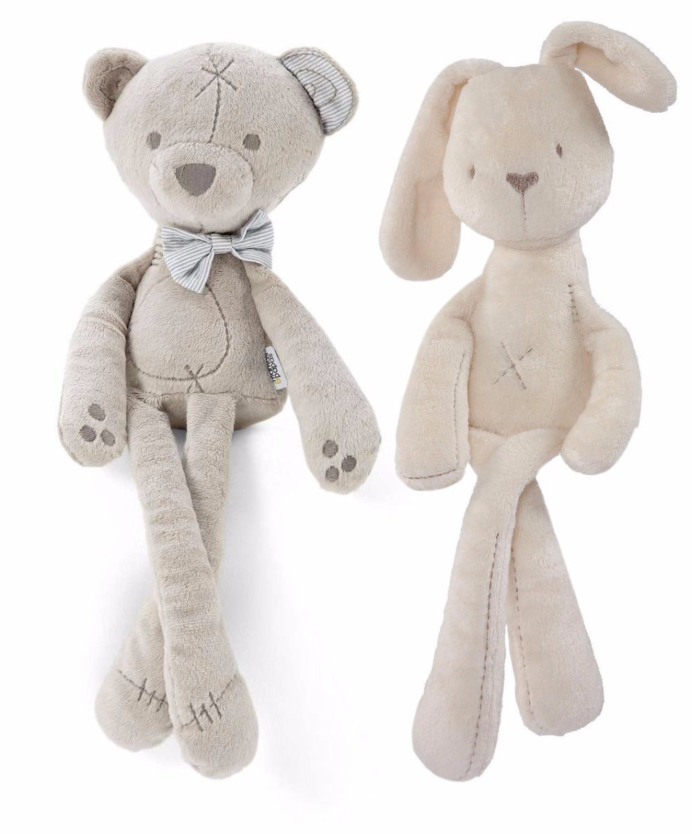 Two plush toys: a beige bear with a bow tie and patterned ears, and a light brown rabbit with long ears. Both have stitched details and soft, elongated limbs.