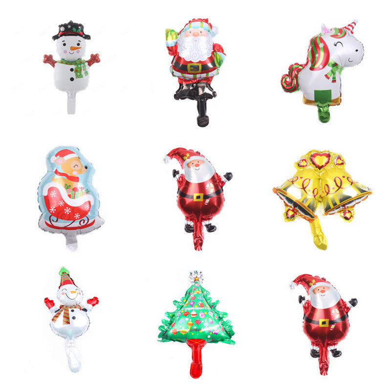 Nine colorful holiday balloons featuring snowmen, Santa, a unicorn, a sleigh, bells, and a Christmas tree, arranged in a 3x3 grid on a white background.