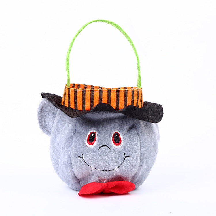 Grey plush basket with a smiling face, red eyes, and a red bow tie. It has a black-and-orange striped top hat with a green handle, resembling a cute Halloween character.