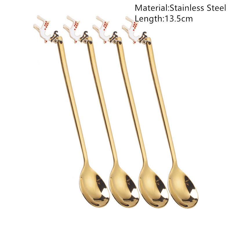 Set of four 13.5cm gold stainless steel spoons with decorative handles featuring white reindeer designs.