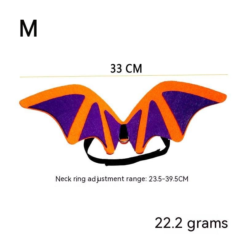 Orange and purple bat wings for pets, size M, measuring 33 cm wide. Neck ring adjustable from 23.5 to 39.5 cm. Weighs 22.2 grams, features a black strap.