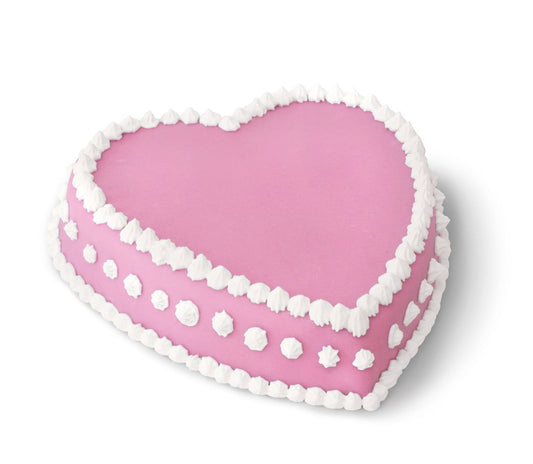 A heart-shaped cake with pink icing, decorated with white frosting along the edges and dots on the sides, against a white background.